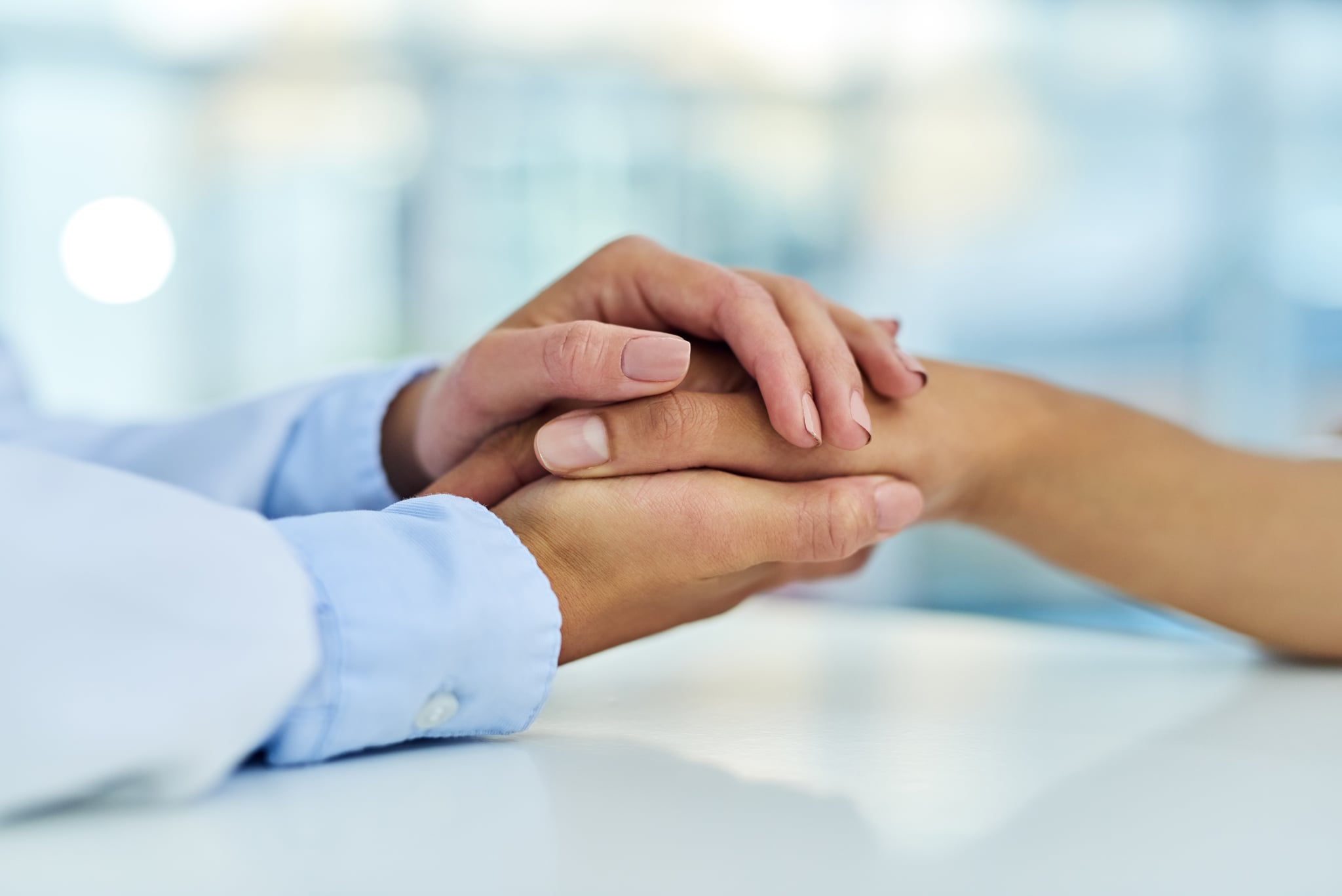 Closeup shot of a doctor holding a patient's hand in comfort