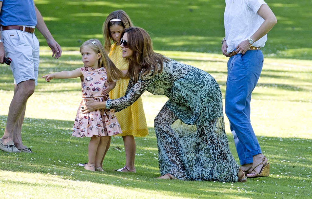 Princess Mary was hands-on with her young daughters during a photo shoot in 2014.