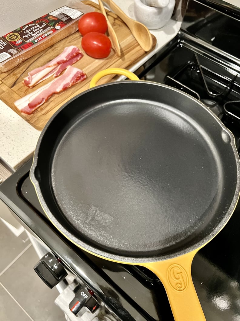 The Great Jones King Sear cast iron pan in shade Mustard on stove.