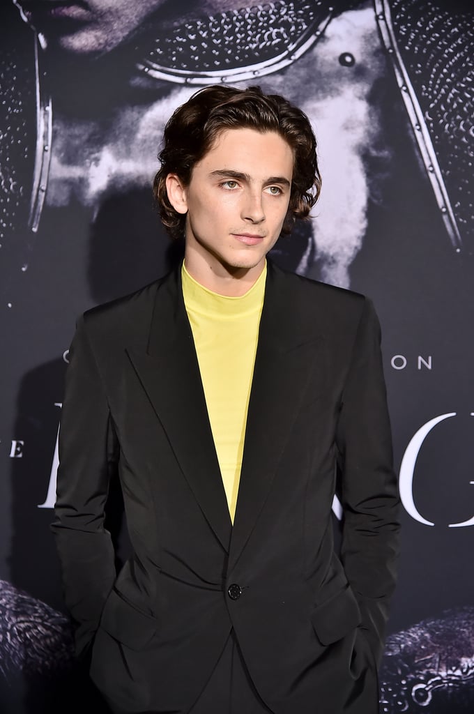 Timothée's neon yellow mockneck shirt offered a pop of color to the Givenchy suit he wore to the New York premiere of The King.