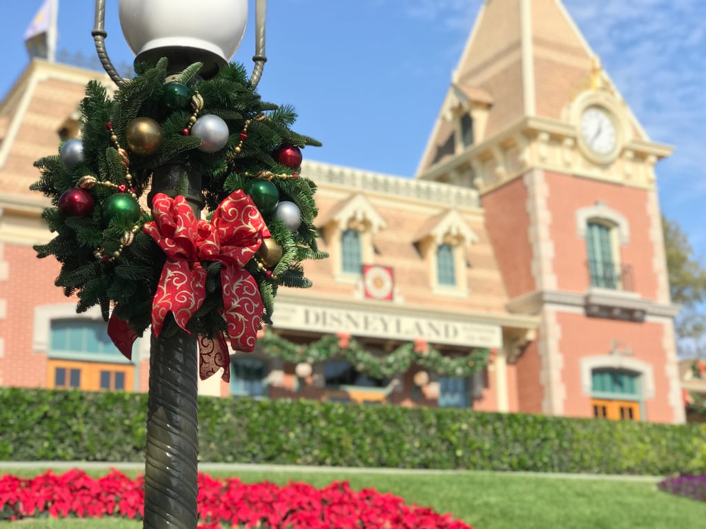 Guests are greeted at Disneyland Main Street Train Station with a hint of the holiday cheer to come upon entering the park.