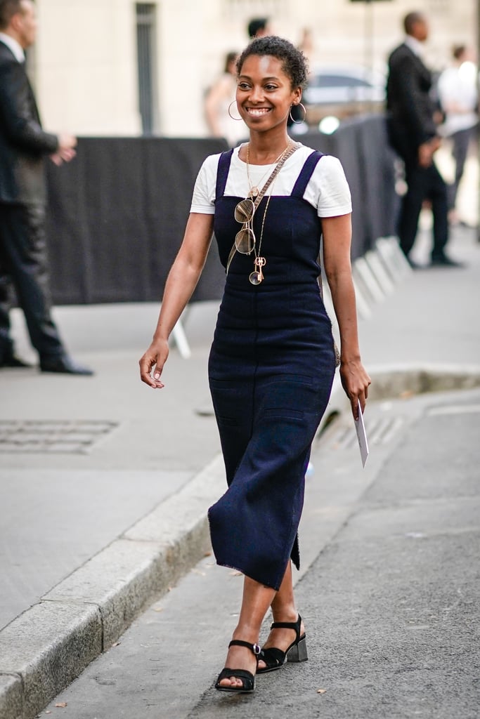 Keep it classic and easy with a white tee and navy mid-length dress on top.