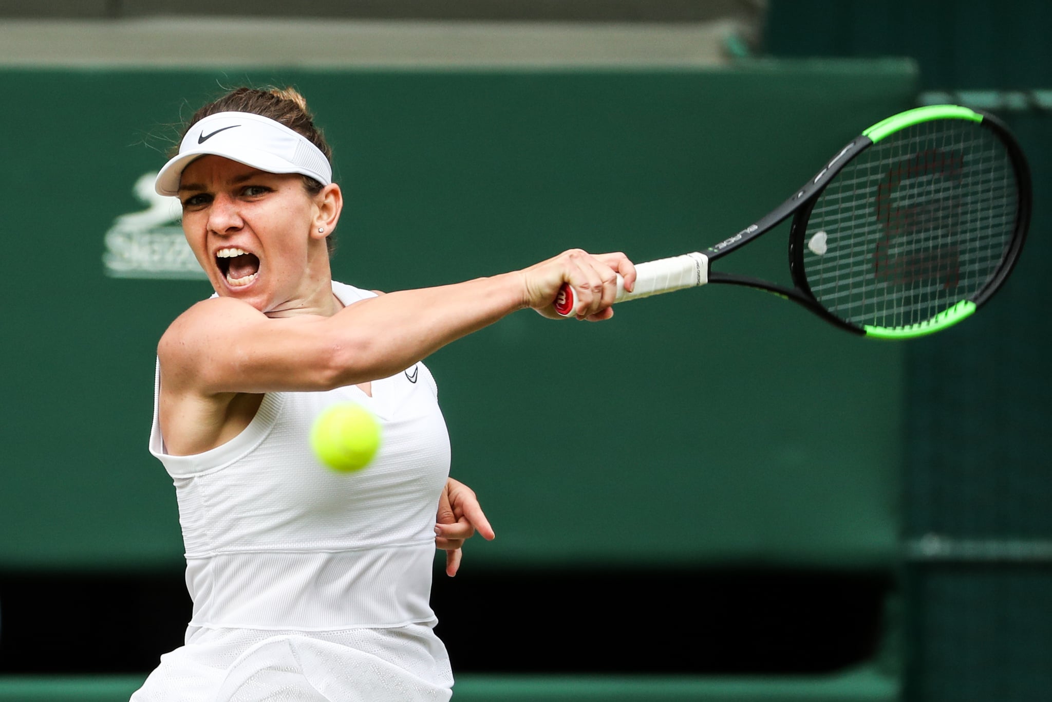 LONDON, ENGLAND - JULY 11: Simona Halep of Romania plays a forehand in her Ladies' Singles semi-final match against Elina Svitolina of Ukraine during Day Ten of The Championships - Wimbledon 2019 at All England Lawn Tennis and Croquet Club on July 11, 2019 in London, England. (Photo by Shi Tang/Getty Images)