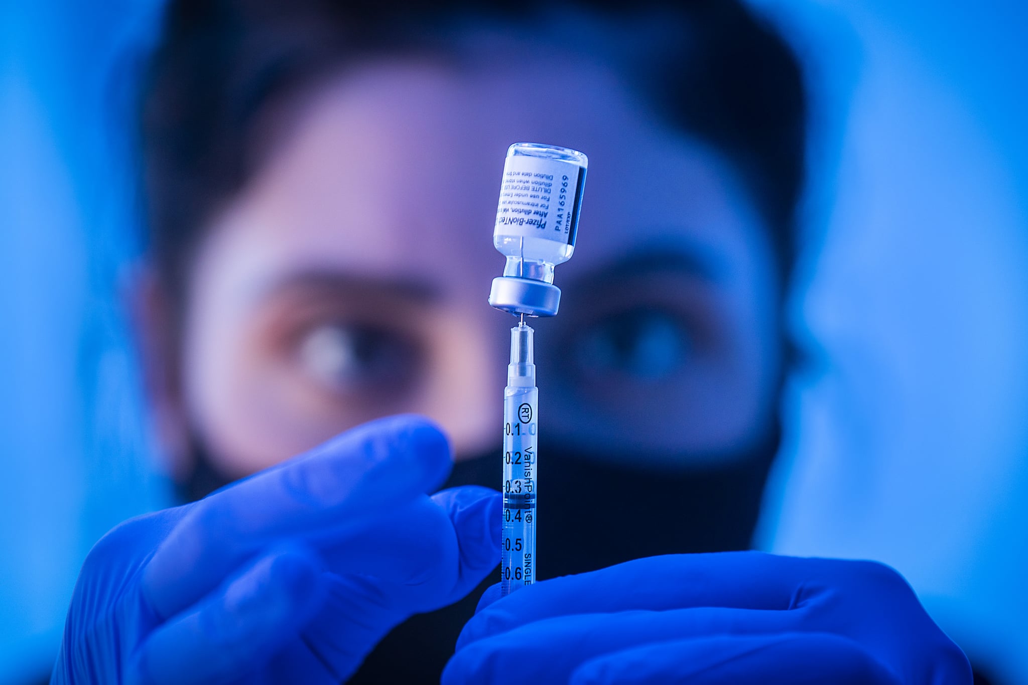 Los Angeles, CA - April 15:  Liesl Eibschutz, a medical student from Dartmouth University, loads a syringe with Pfizer COVID-19 vaccine before giving it to people on the first day that people ages 16 and up can receive the vaccine at Kedren Health on Thursday, April 15, 2021 in Los Angeles, CA. Award-winning television producer, Marti Noxon, whos a big fan of Kedren Vaccines, sent an In-N-Out truck to feed 200+ volunteers who help make this vaccine program such a huge success and she did so on the day that vaccines are being made available to all people 16+ in Los Angeles. (Allen J. Schaben / Los Angeles Times via Getty Images)