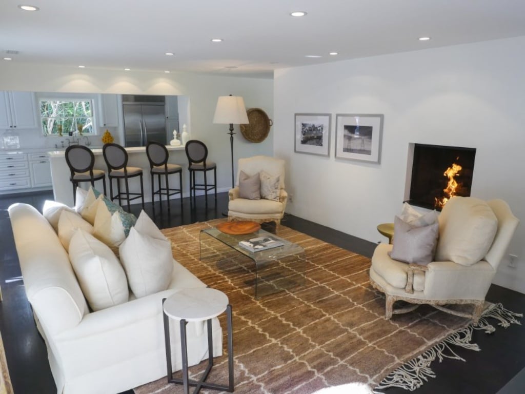 A minimal fireplace acts as the finishing touch in the living room. 
Source: Sotheby's Realty