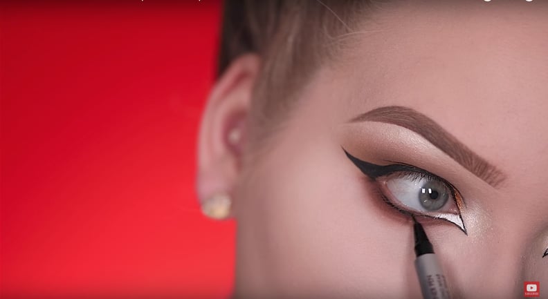 Line your lower lashes with liquid liner.