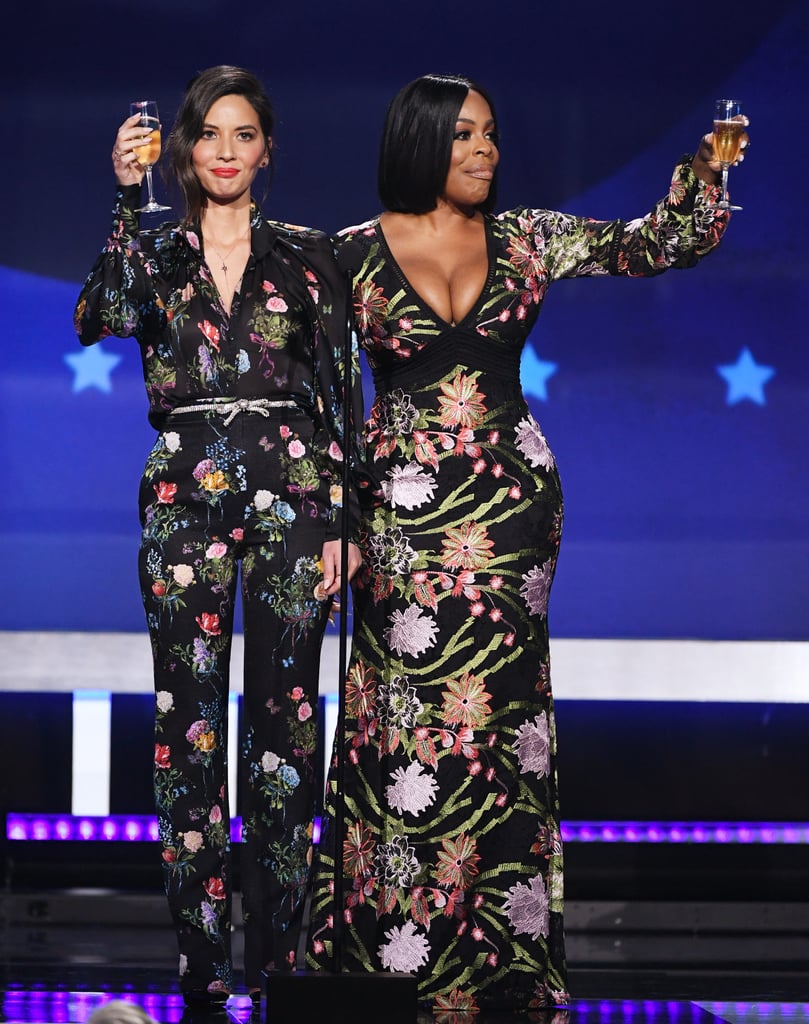 Wearing a floral embroidered jumpsuit by Monique Lhuillier with Christian Louboutin shoes. She finished off her look with jewelry by Sara Weinstock and Graziela Gems.