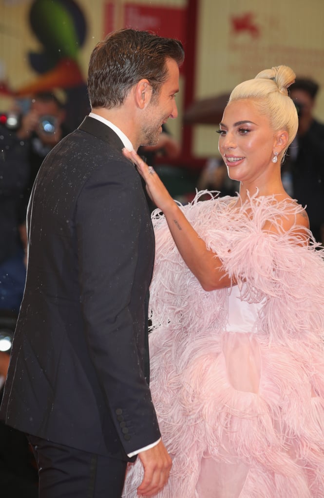 Gaga returned the favour by helping Bradley with his suit. That's what friends are for, right?