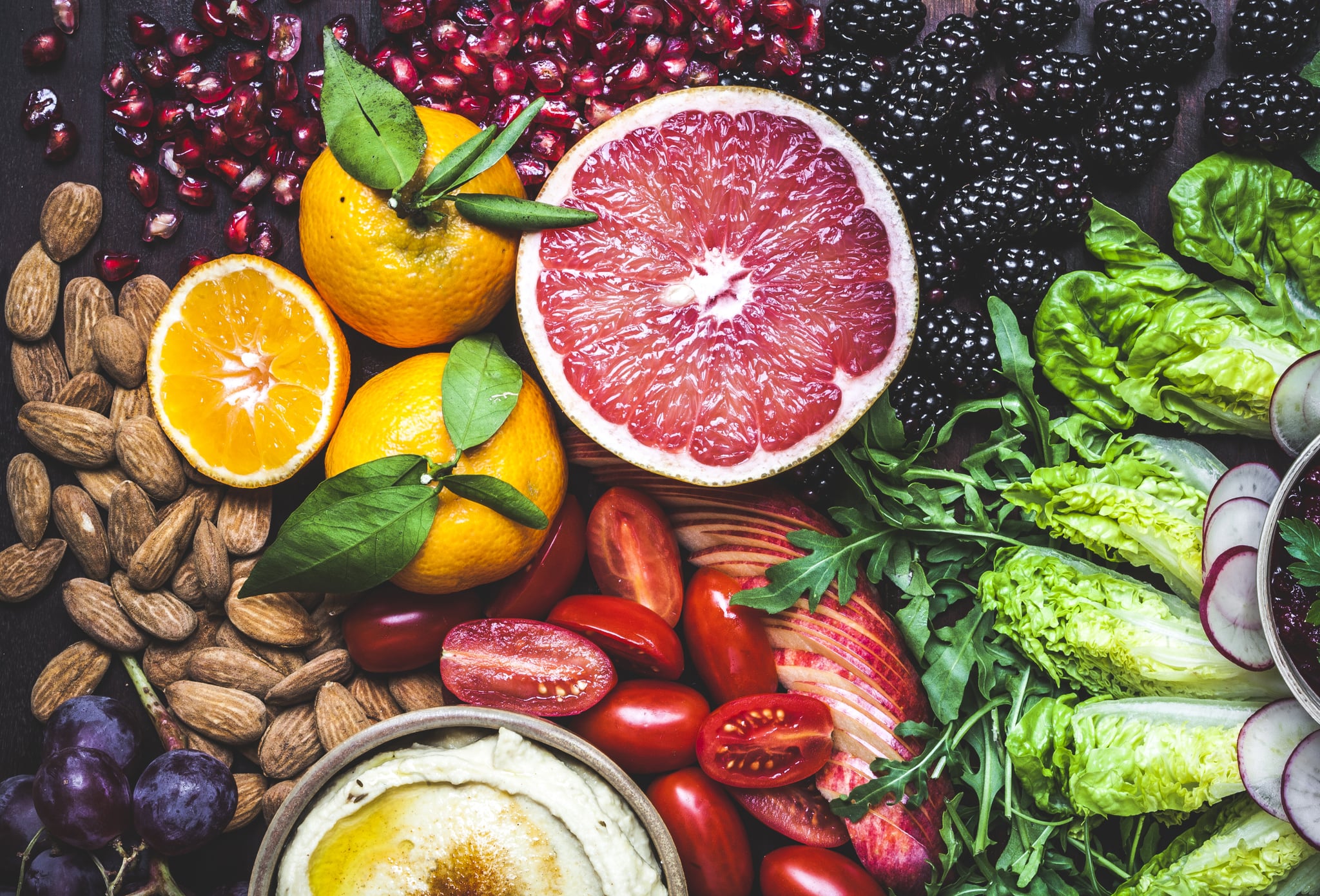 A rainbow of colours and textures in this vibrant and healthy snack board of fruit, vegetables, dips, nuts and olives. Citrus fruits, grapes, tropical fruits and berries add colour to the spread. Hazelnuts,almonds, walnuts, kalamata olives and home made dips of hummus, beetroot and pumpkin are surrounded by salad sliced for a fun, healthy way to snack. Raw healthy food, ready for a party.