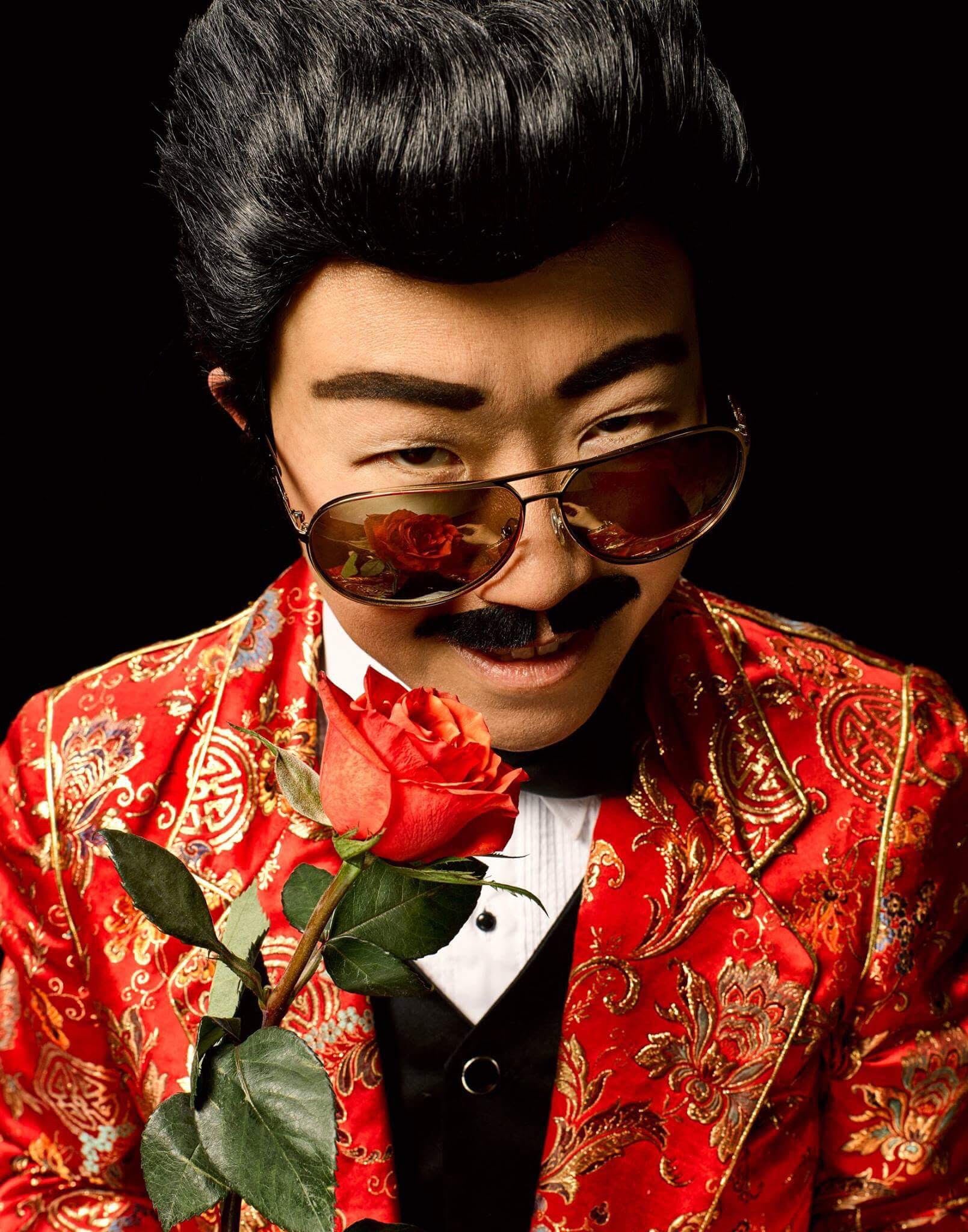 Drag king Wang Newton holding a rose