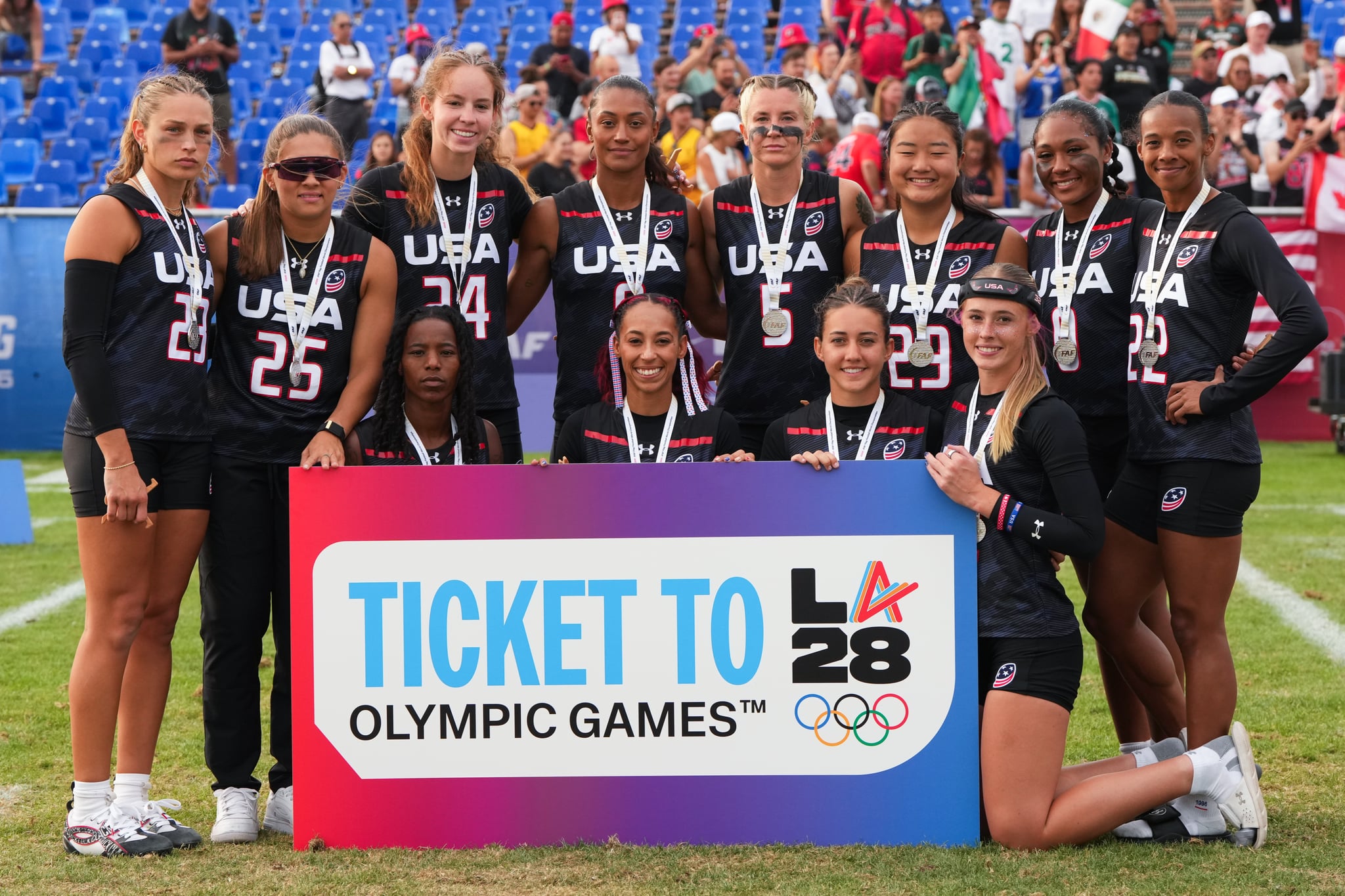 United States players pose for a photograph with a banner depicting their ticket to the LA28 Olympic Summer Games.