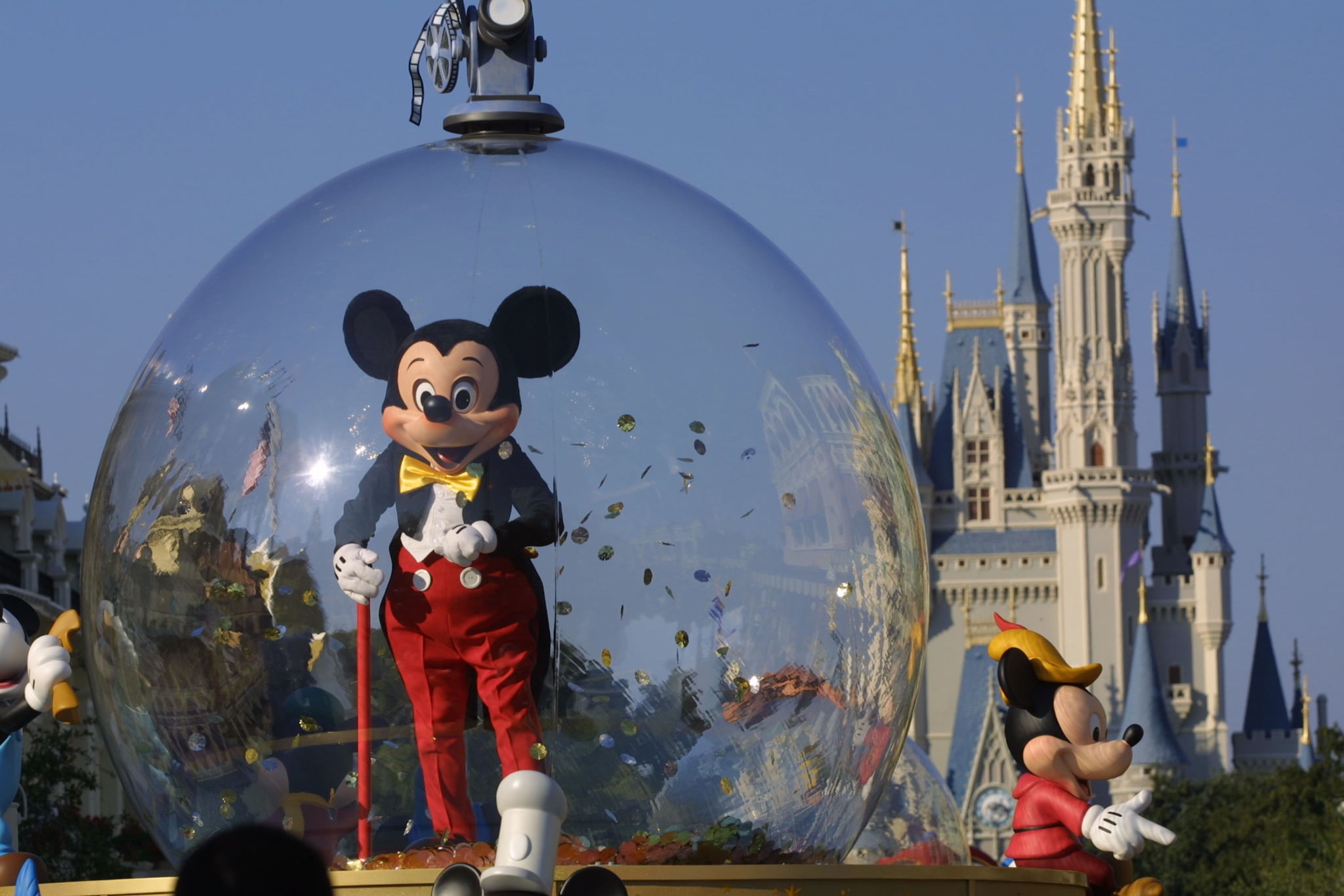 397155 06: Mickey Mouse rides in a parade through Main Street, USA with Cinderella's castle in the background at Disney World's Magic Kingdom November 11, 2001 in Orlando, Florida. (Photo by Joe Raedle/Getty Images)