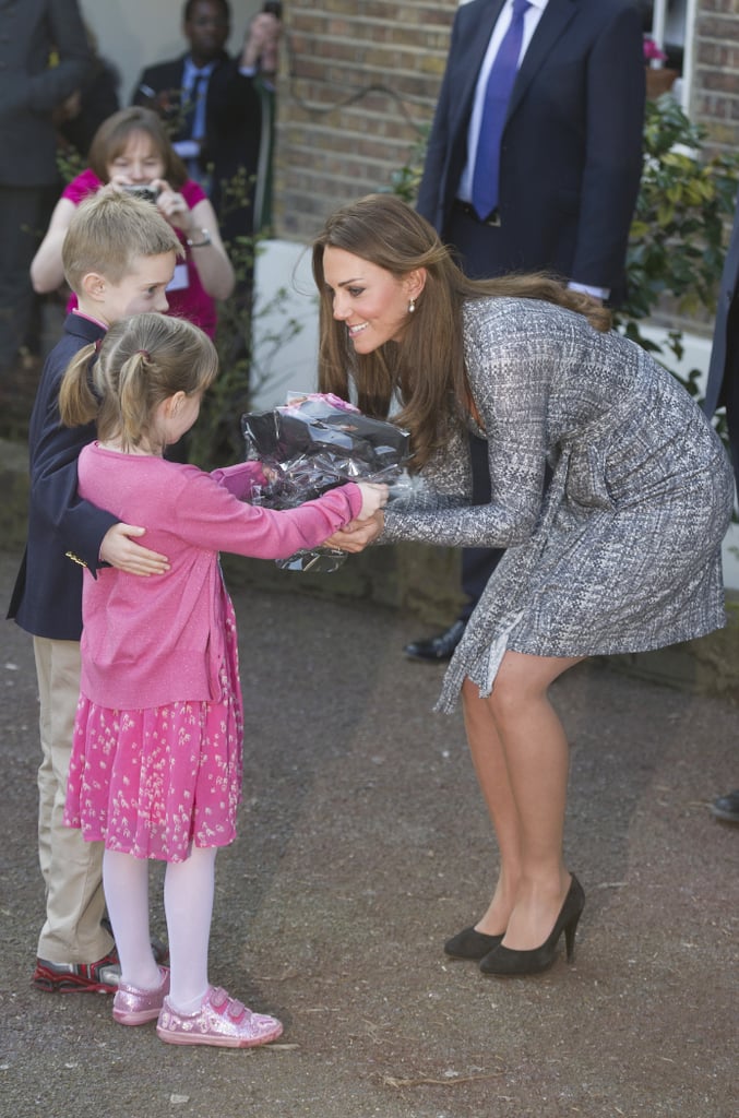 Kate beamed while getting flowers from children at the Hope House charity in London in February 2013.