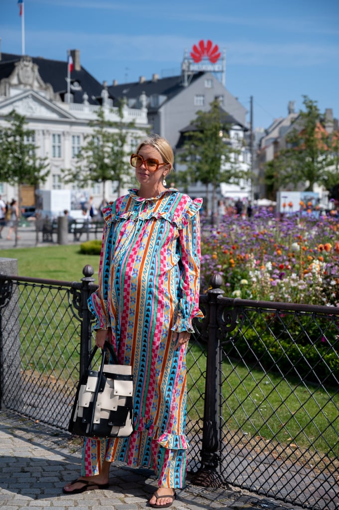 Accentuate a baby bump with a colourful puff-sleeve dress and oversize sunglasses