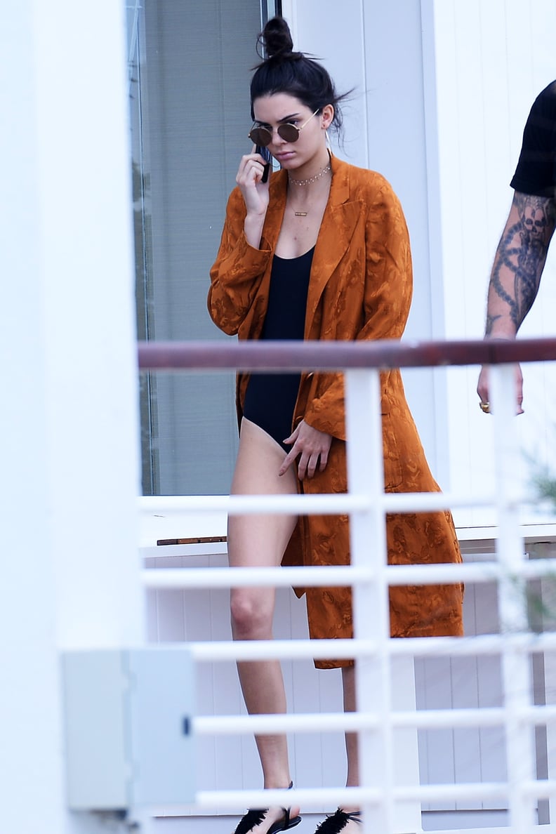 But She Broke Out the Duster Again on Friday, Rocking It Over a Black Swimsuit
