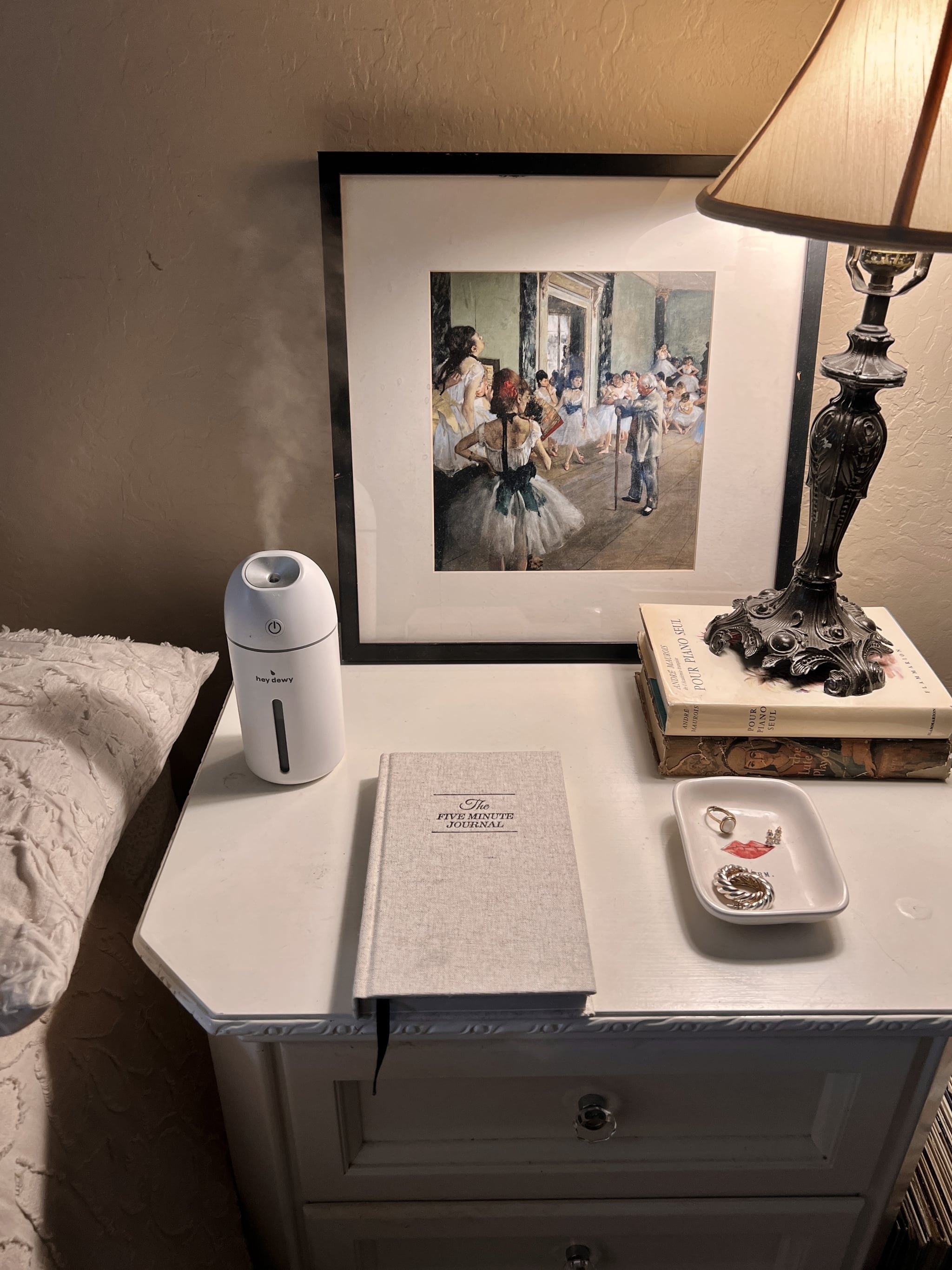 hey dewy portable facial humidifier on a nightstand