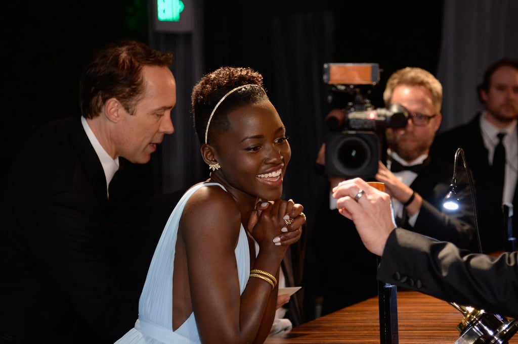 Lupita smiled while checking over her name.