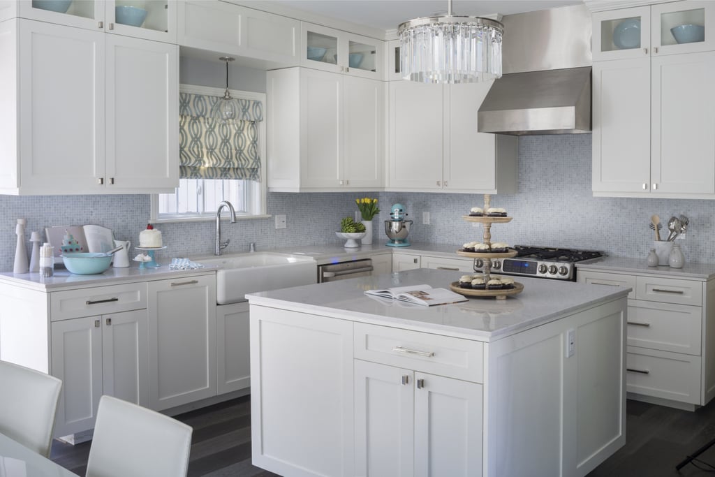 Lonni designed a bright kitchen that stayed true to Melissa and Mark's aesthetic. The countertops are white marble Silestone.