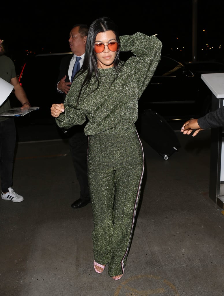 Style '70s-inspired sunglasses with a glittery green tracksuit.