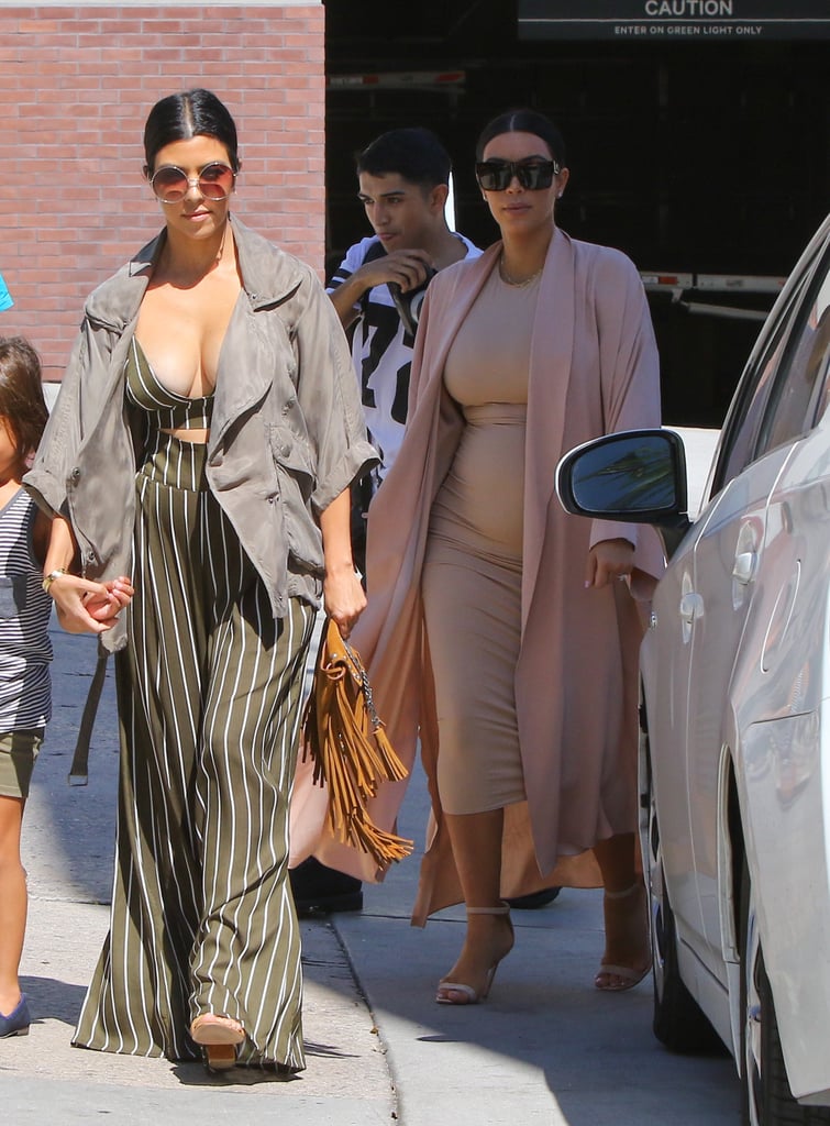 Kourtney's crop top showed off lots of cleavage! She finished her look with huge round statement sunglasses and a fringe bag.