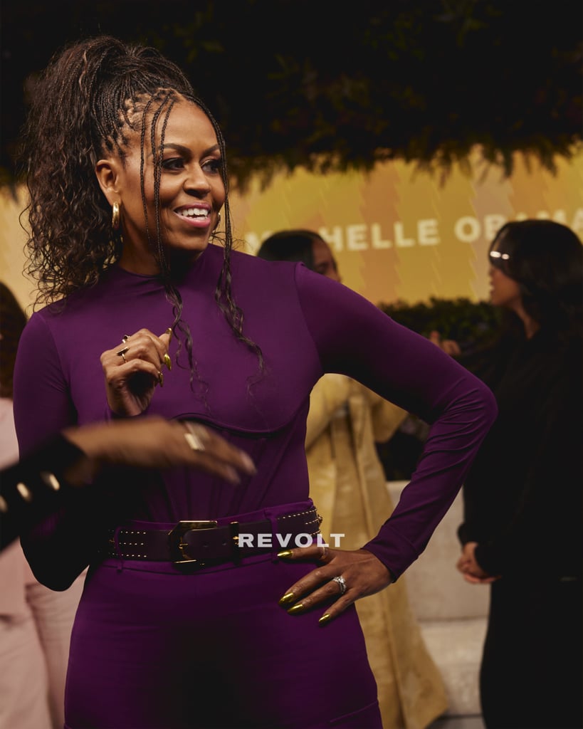 Chatting with stars like H.E.R, Kelly Rowland, and Tina Knowles-Lawson on Revolt, Obama dressed in a corseted plum-colored top and matching belted trousers.