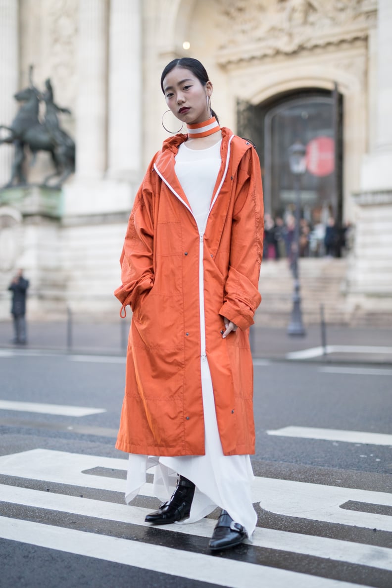 Pair Your Flowy Dress With a Bright Orange Coat and Black Boots