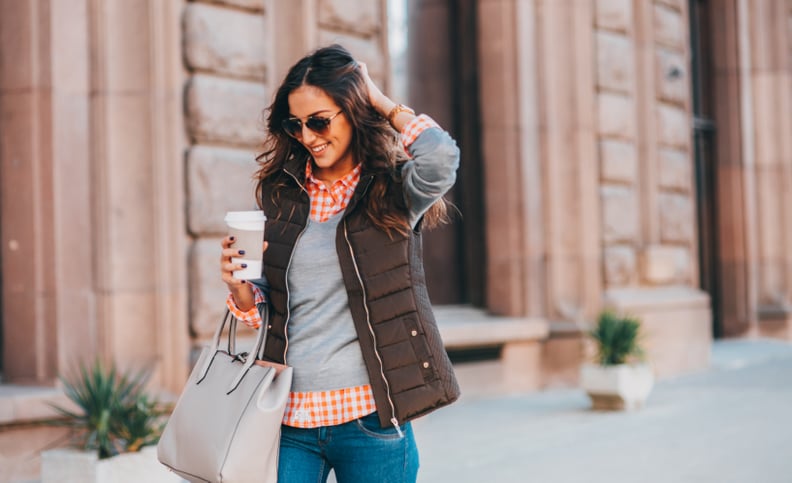 Woman drinking coffee outdoors.