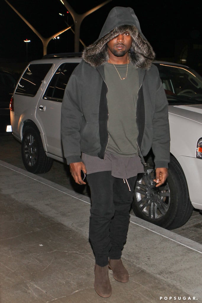 Kanye West stayed warm at LAX on Friday.
