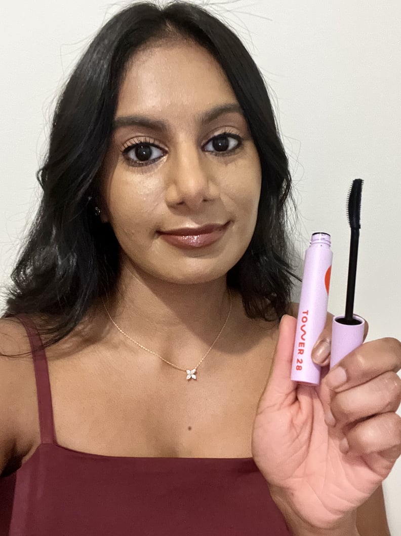 Woman holding the Tower 28 MakeWaves Mascara.