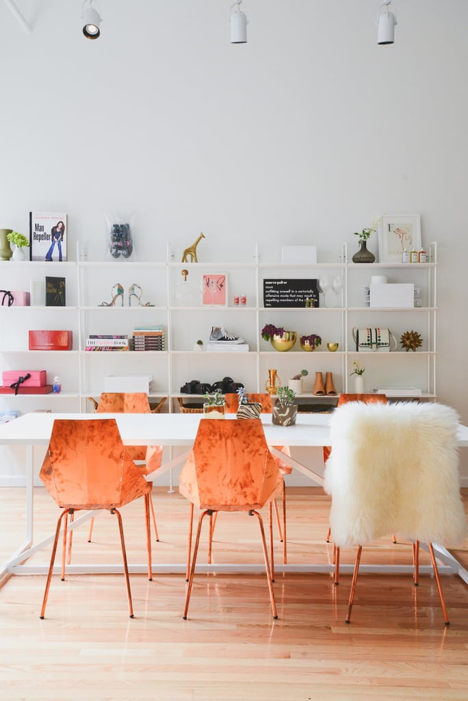 A long table doubles as a communal desk for Man Repeller staff to gather around. Instead of standard office chairs, this workplace is stocked with dazzling copper chairs. A sheepskin throw is on hand in case extra cushioning is needed. 
Photo by Claire Esparros via Style Me Pretty