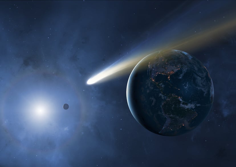 Illustration of the Earth, Moon and Sun showing a passing comet. Cities are seen glistening, defining the edges of the Earth's continents. Comets are balls of loosely packed 'dirty ice'. As they near the Sun, their gases sublimate and form long tails blus