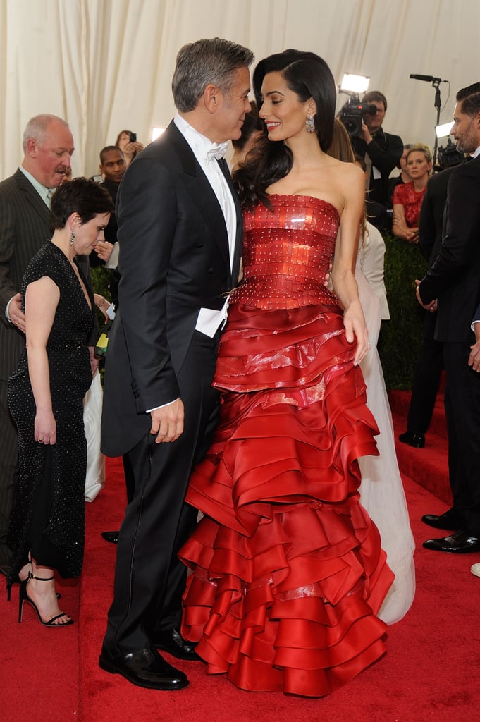 Amal confidently pulled off a fiery red Maison Margiela gown by John Galliano at the 2015 Met Gala.