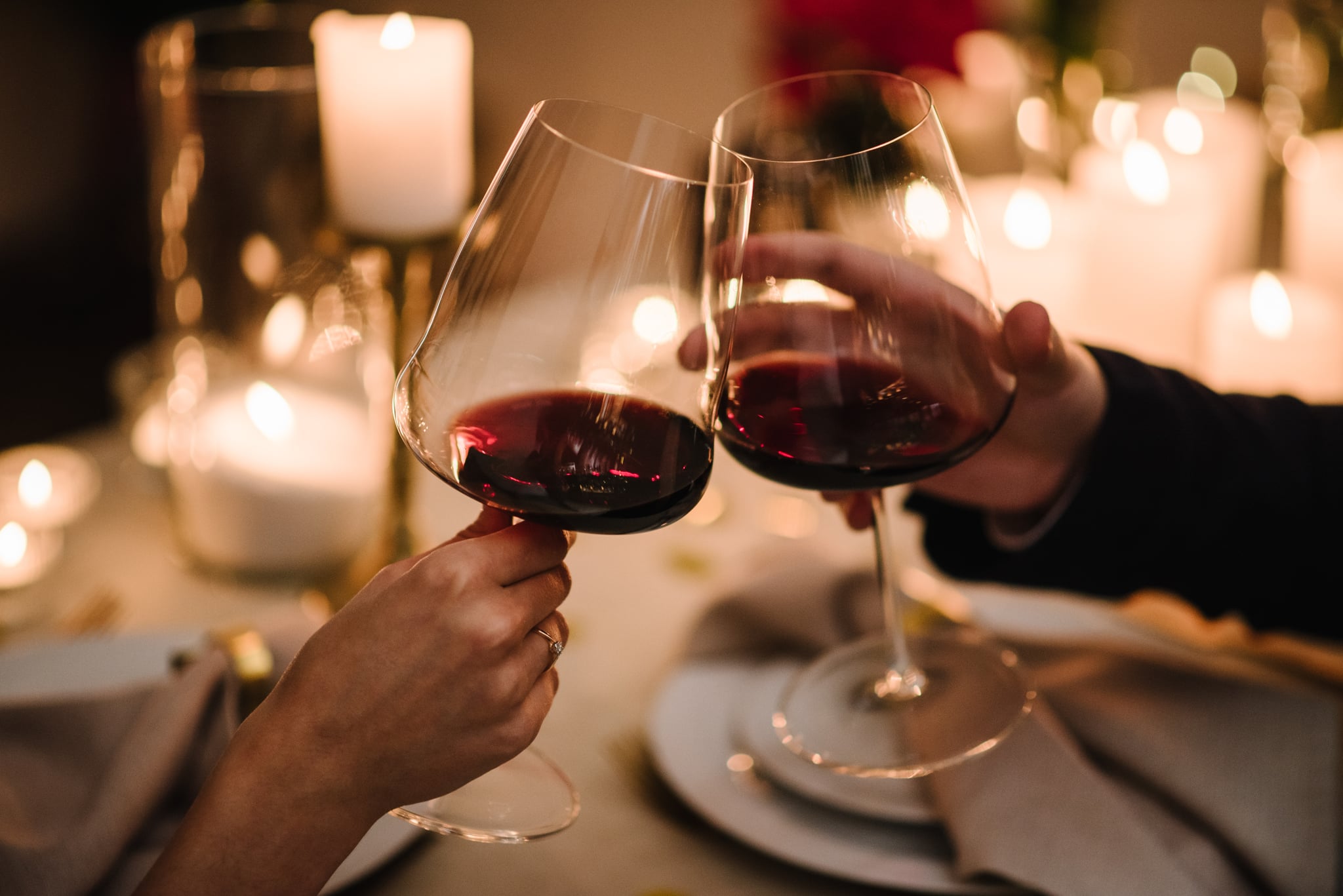 cheersing with non-alcoholic red wine at dinner