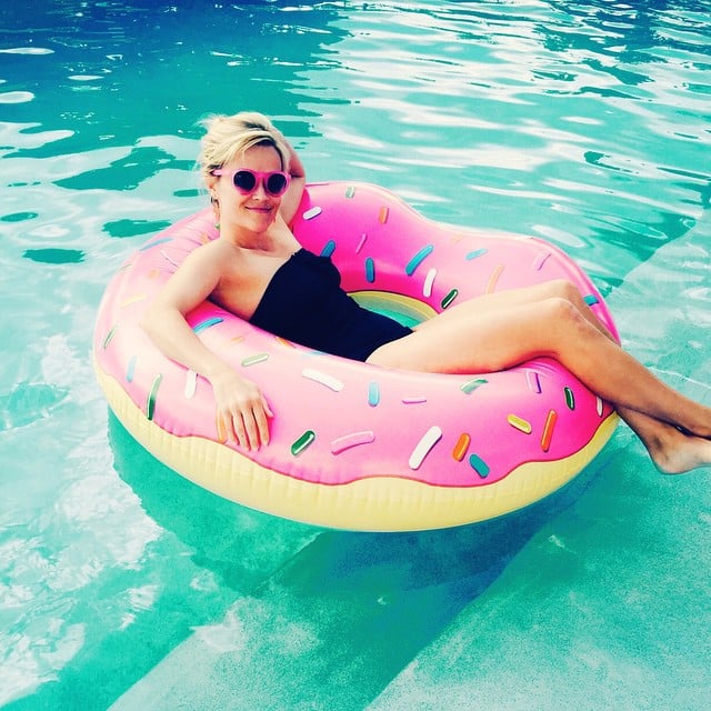 Reese captioned this pool snap, "#DonutWorryBeHappy?!"