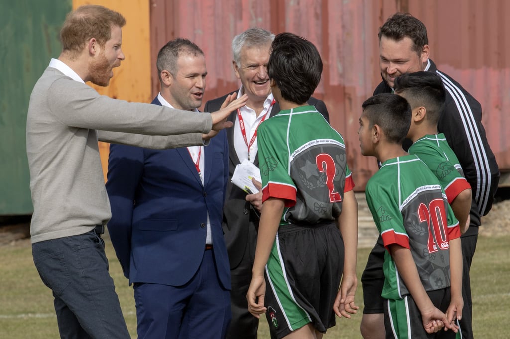 Prince Harry Hugs Kids at Lealands High School