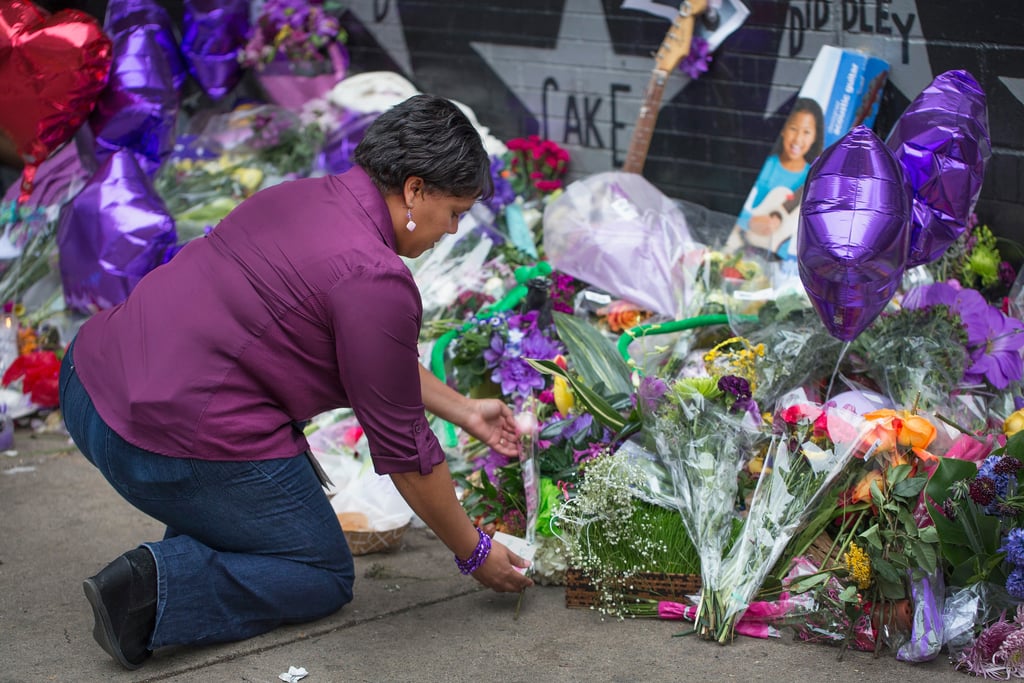 A woman laid flowers on the sidewalk outside First Avenue.