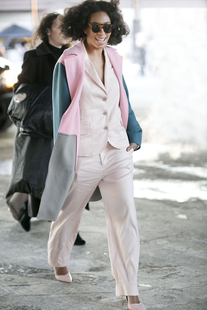 Solange added interest to a pale suit with a pop of pastel pink on her coat. 
Source: Tim Regas