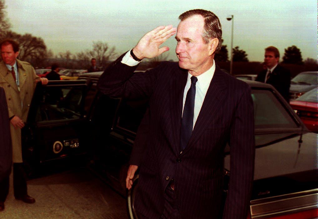 U.S. President George Bush salutes as he leaves the Pentagon 14 December 1992. Bush was briefed by U.S. Defence Secretary Richard Cheney and Chairman of the Joint Chiefs of Staff General Colin Powell on the current situation of U.S. relief efforts in Somalia.         (Photo credit should read RENAUD GIROUX/AFP/Getty Images)