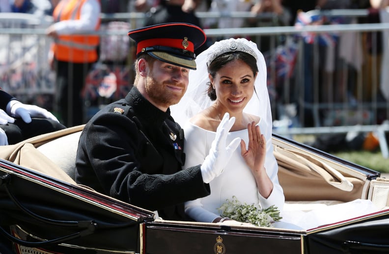 WINDSOR, ENGLAND - MAY 19: (EDITORS NOTE: Retransmission of #960087582 with alternate crop.) Prince Harry, Duke of Sussex and Meghan, Duchess of Sussex wave from the Ascot Landau Carriage during their carriage procession on Castle Hill outside Windsor Cas