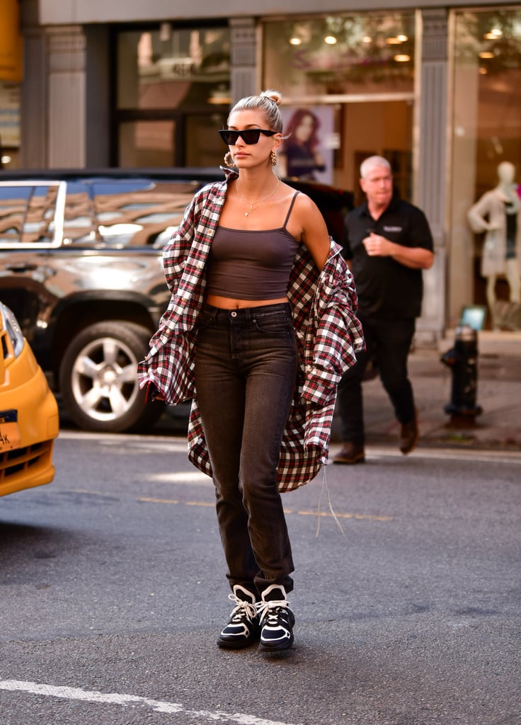 Hailey looked effortless in a Mastermind World flannel, jeans, a Prix tank, Prada bag, Louis Vuitton sneakers, Céline sunglasses, and jewels by Kendra Scott and Jennifer Fisher when she stepped out in the Big Apple in August.