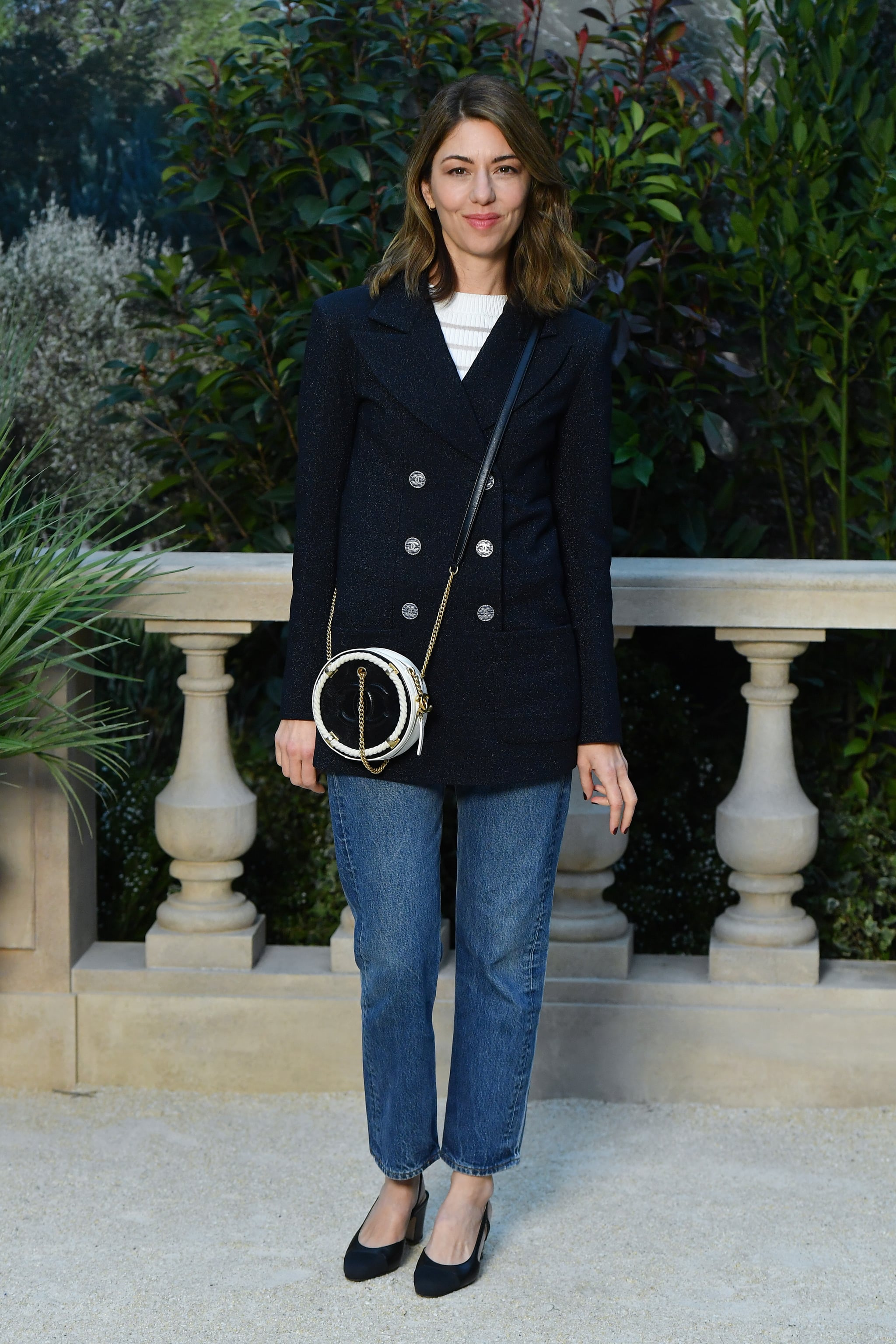 Sofia Coppola dressed casually in a blazer and crossbody bag.