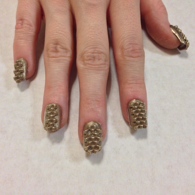 "Kingdom" nails printed in brass. 
Source: Instagram user thelasergirls