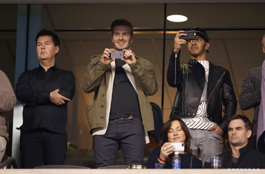David Beckham and Lewis Hamilton captured the game on their phones.