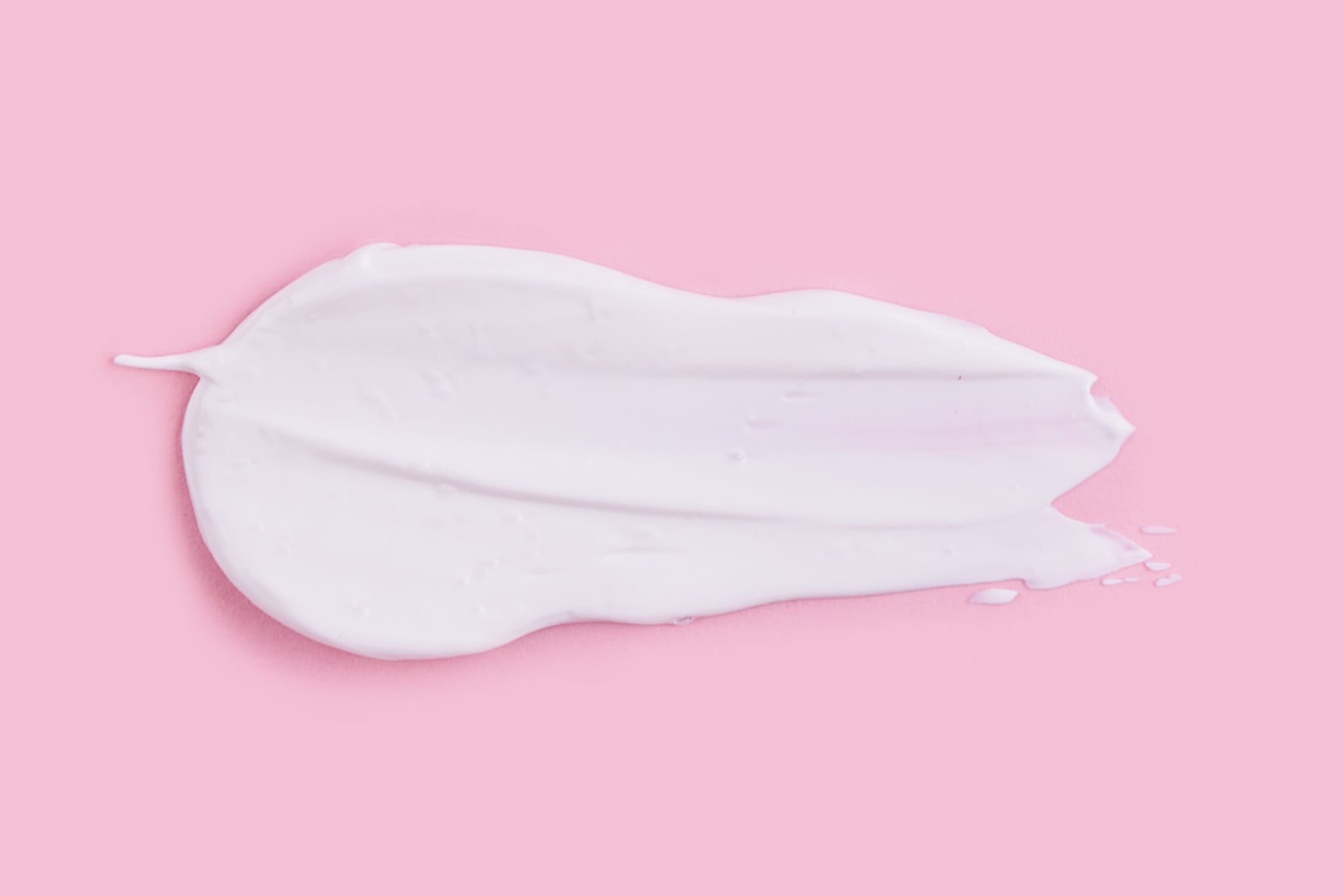 Smear of natural moisturiser in pink background. Cream, Lotion for face or body. Skin care.