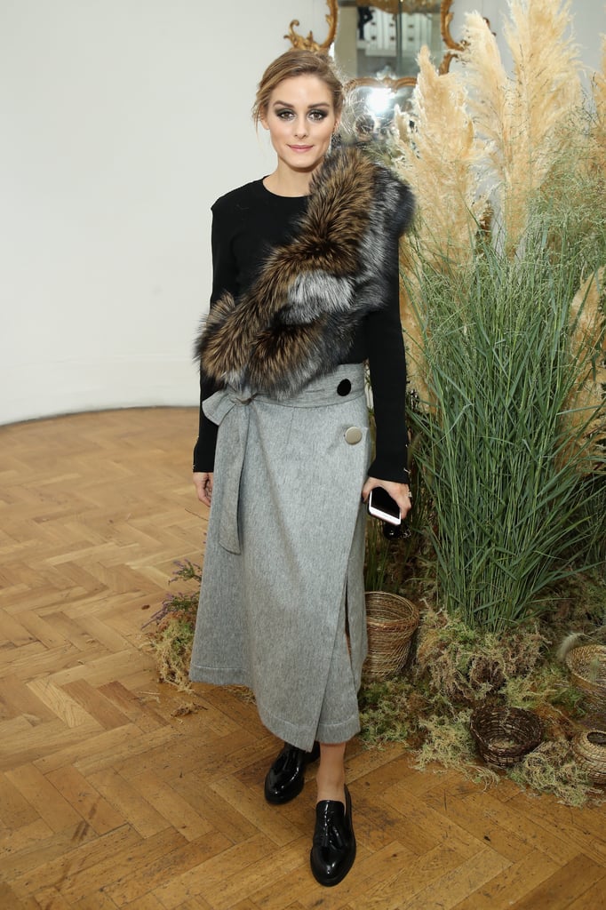 Ever the mix master, Olivia showed her styling prowess, adding a furry finish to a wrap skirt and crew-neck sweater at London Fashion Week.