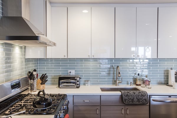 White And Blue Kitchen Features White Shaker Cabinets Paired With