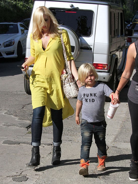 A great way to wear a Summer dress in the Fall, Gwen ran errands with her son in a yellow tunic and jeans.