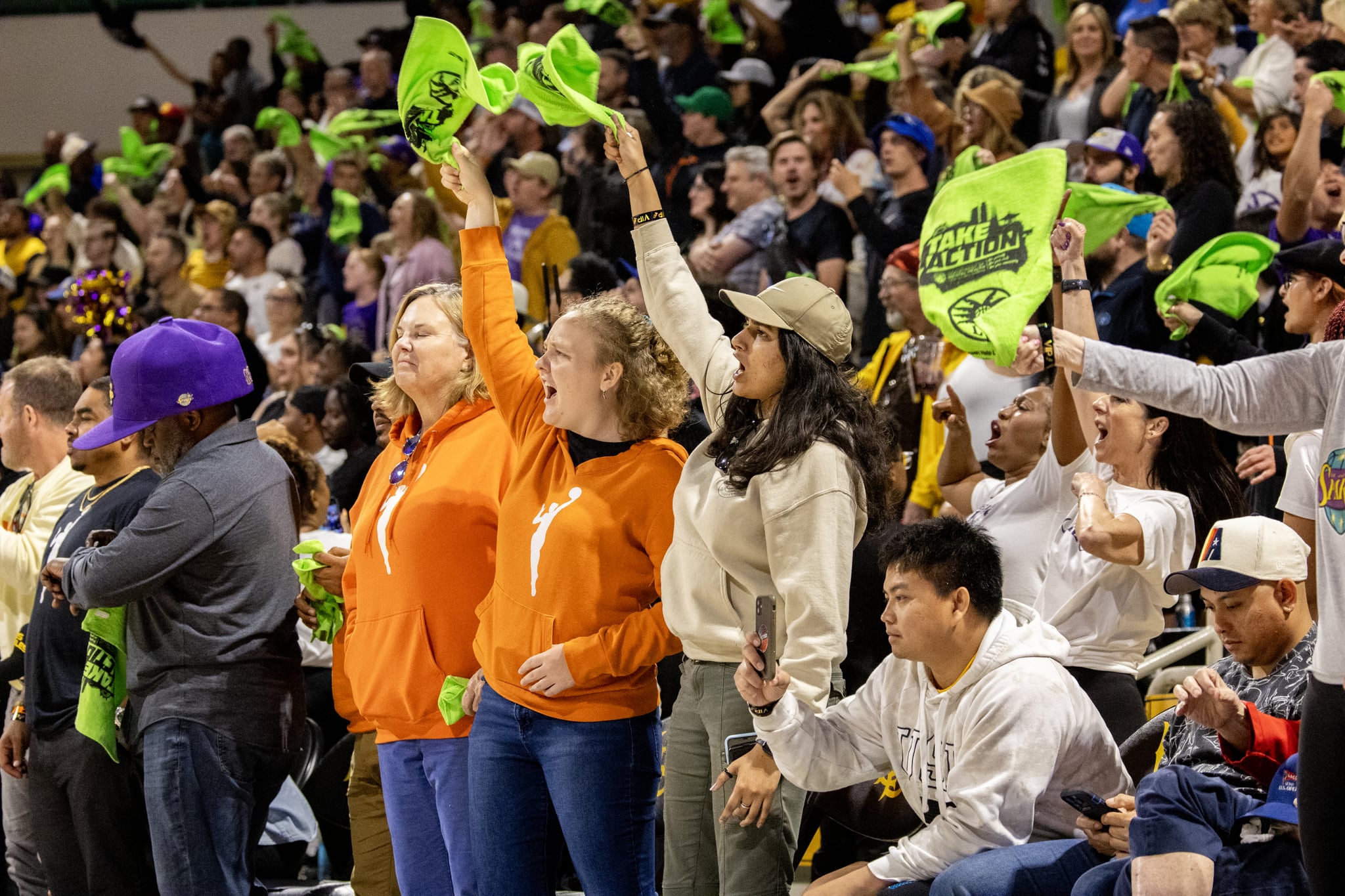 The crowd waves rally towels during the LA Sparks game against the Washington Mystics.