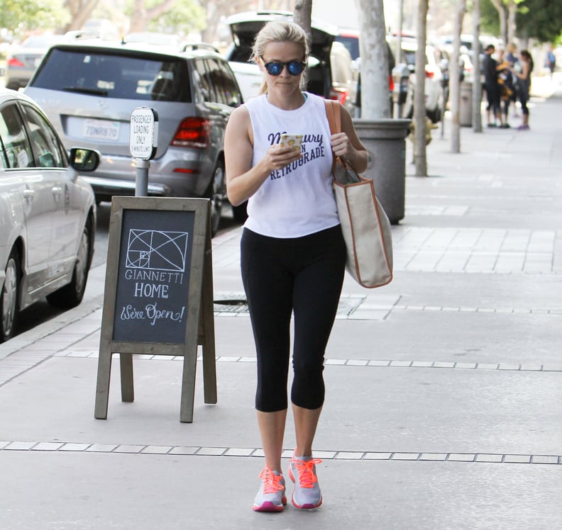 And Paired Her Look With Black Leggings and a Bright Pair of Kicks