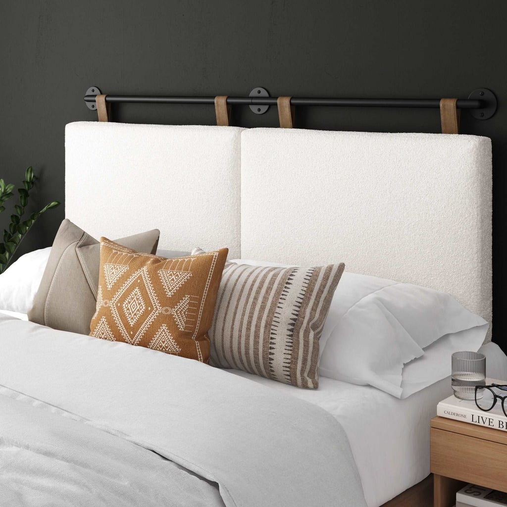 Nathan James Boucle Upholstered Queen Wall Mount Headboard ($160, originally $190)
Bouclé adds warmth and softness here, but the slim metal bar keeps things from veering too plush. The under-$200 price tag is also very much a double take.
What we love:
The price is hard to beat for how stylish it is.
Adjustable hanging straps make it easy to set the height exactly where you want it.
The bouclé upholstery adds soft texture and a cozy feel without overwhelming the space.
Who it's best for:
Someone who wants a softer, more styled headboard look.
Who should avoid it:
If you want a fully upholstered bed frame or a headboard with substantial padding and heft, this slimmer profile may feel too minimal.
The Details: Material: Boucle | Sizes: King and Queen | Color Options: 1